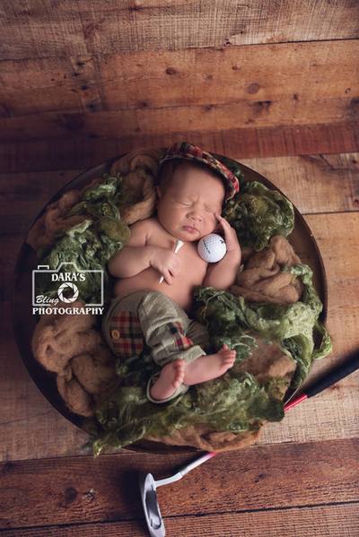 Tamarac birth photographer newborn baby boy with bear in fur nest