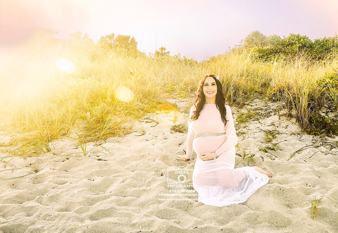 pregnant woman sitting on beach
