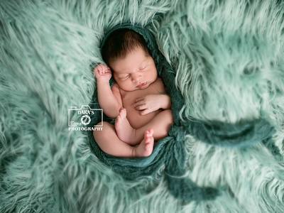 Hialeah birth photographer newborn baby boy green wrap on green fur