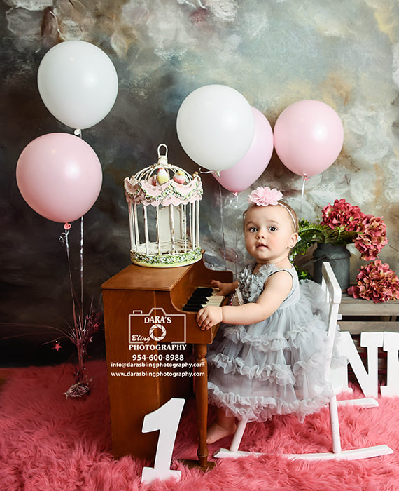 one year milestone photo shoot baby playing piano