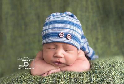Natural birthmarks Margate birth photographer newborn baby boy on green blanket with blue hat