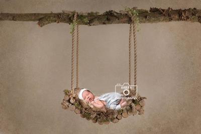Newborn baby boy on wooden swing Aventura newborn photographer