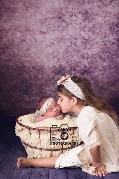 Hollywood Florida birth photographer big sister kissing newborn baby sister in bucket