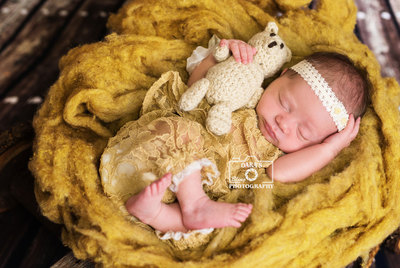 Mother son newborn session lying on rug South Florida birth photographer