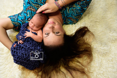 Delray Beach newborn photographer mother son lying on fur rug