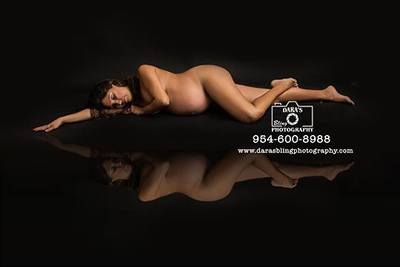 Nude pregnant women laying done reflection