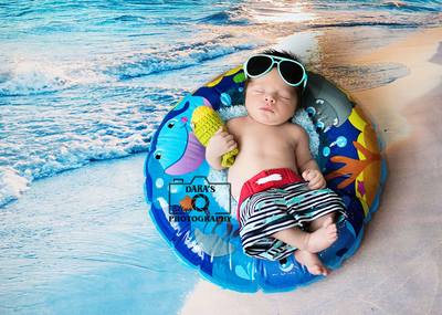 Dania Beach newborn baby photographer baby boy in float with fish and sunglasses